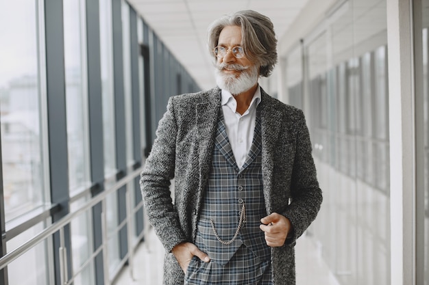 Free Photo close up portrait of grinning old-fashioned man. elegant man at the office.