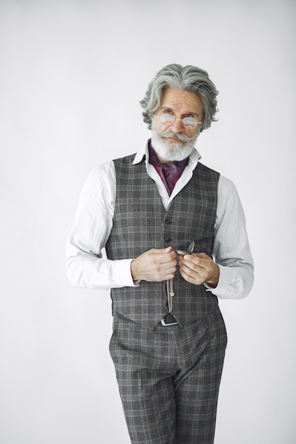 Free Photo close up portrait of grinning old-fashioned man.  grandfather with a clock.