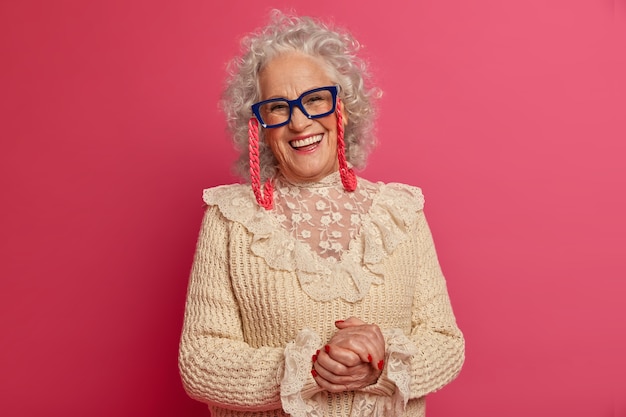 Free Photo close up portrait of happy wrinkled fashionable granny wearing glasses and sweater