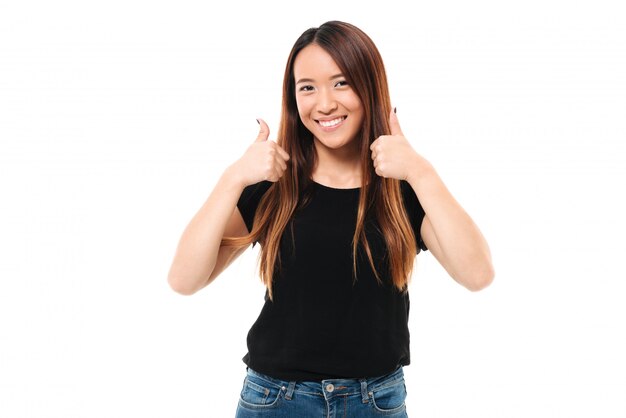 Close-up portrait of happy young asian woman showing thumb up gesture