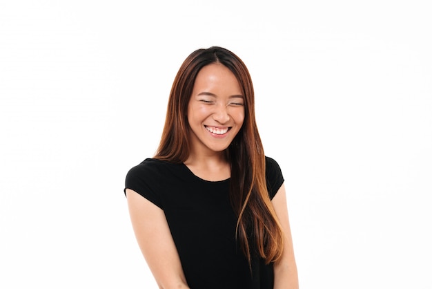 Close-up portrait of laughing attractive asian woman with closed eyes isolated on white 