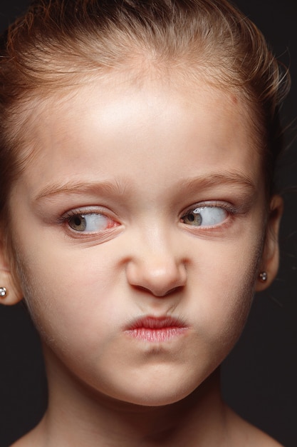 Free Photo close up portrait of little and emotional caucasian girl. highly detail photoshot of female model with well-kept skin and bright facial expression. concept of human emotions. angry, gloomy.