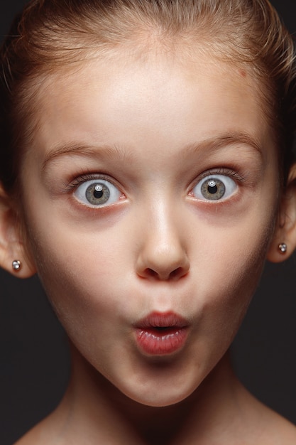 Free Photo close up portrait of little and emotional caucasian girl. highly detail photoshot of female model with well-kept skin and bright facial expression. concept of human emotions. shocked, wondered.