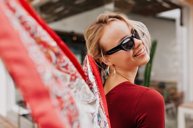 Free Photo close up portrait of lovable stylish woman with blond hair turn around and accessories