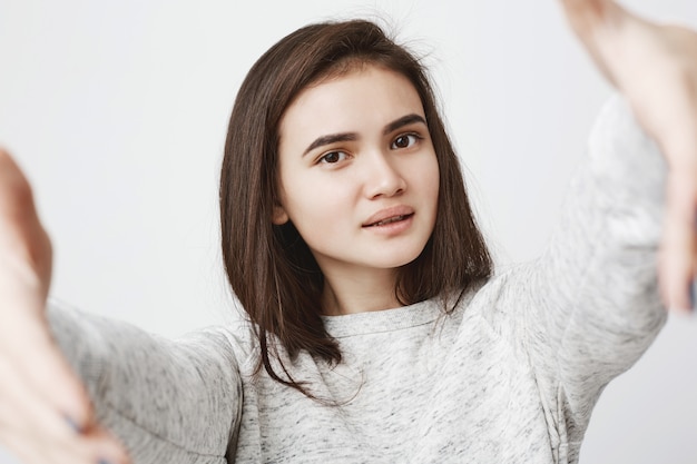 Close up portrait of nice cute european woman stretching her hands