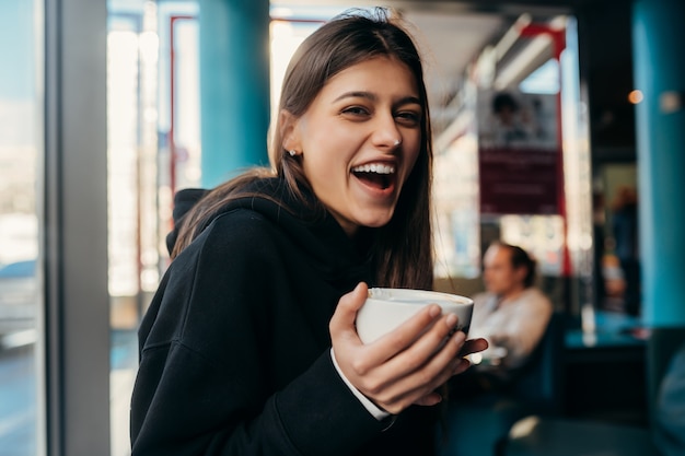 Close up portrait of pretty female drinking coffee.