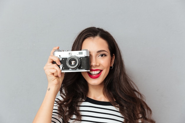 Close up portrait of a pretty woman taking a photo