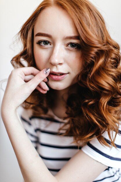 Close-up portrait of red-haired lady with stylish manicure. positive ginger girl posing.