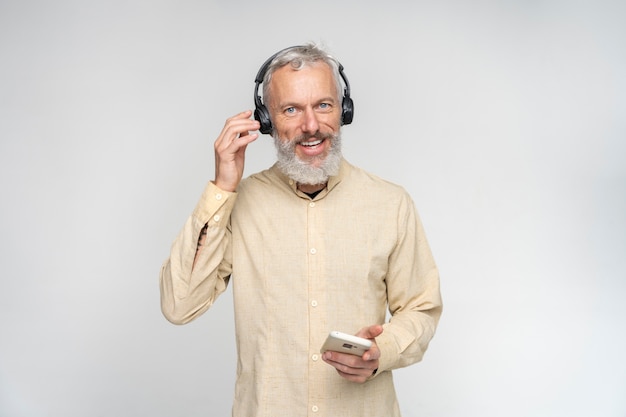 Free Photo close up portrait of senior man listening to music