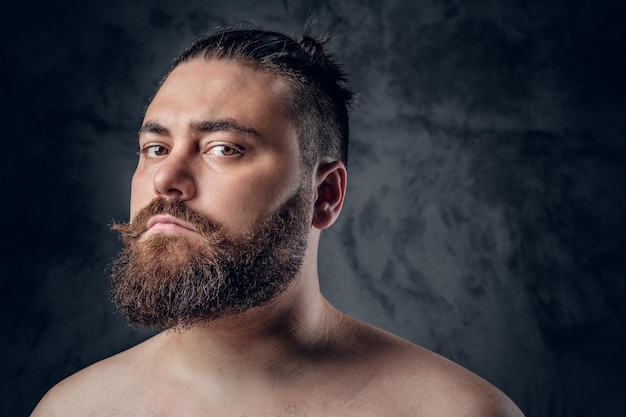 Free photo close up portrait of shirtless beard male on grey background.