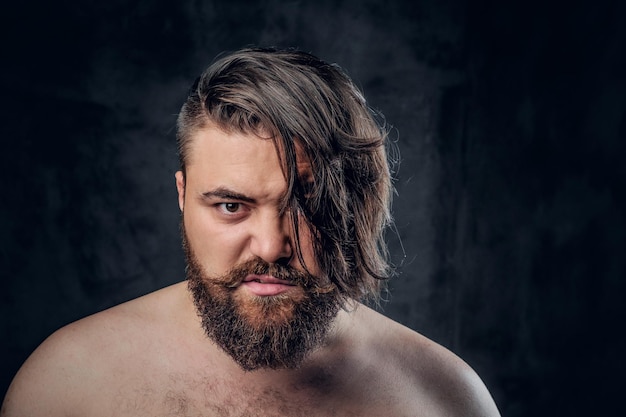 Free photo close up portrait of shirtless beard male on grey background.