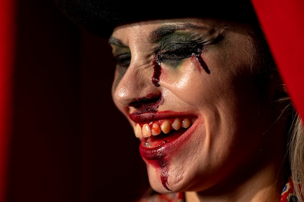 Free photo close-up portrait of sideways clown woman with her eyes closed