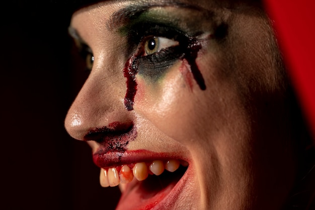 Close-up portrait of spooky make-up woman with blood 