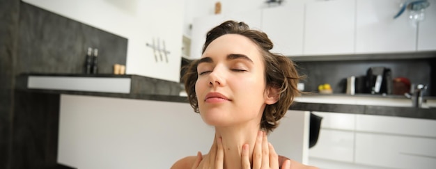 Close up portrait of sportswoman fitness woman massaging her neck warmup her body after workout