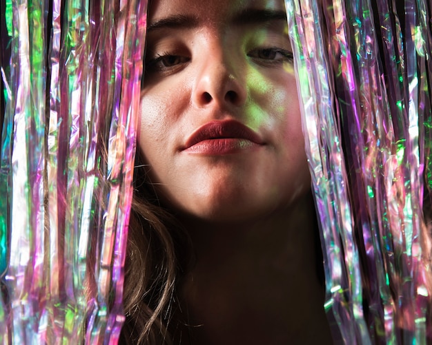 Free photo close-up portrait of woman and curtain of sparkles