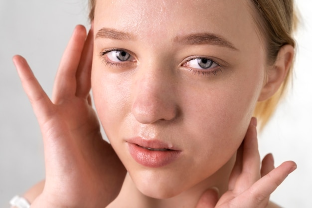 Free Photo close up portrait of woman with hydrated skin