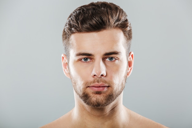 Close up portrait of a young bearded man face