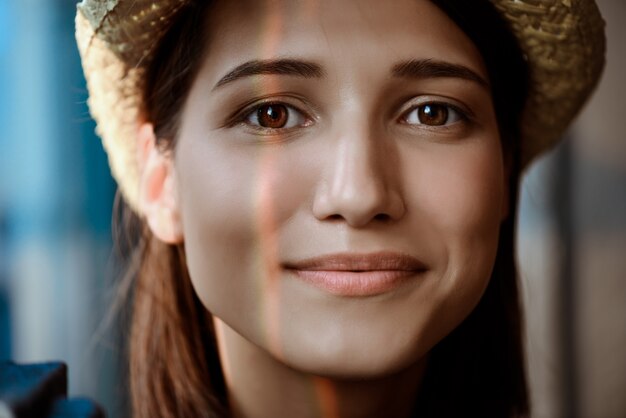 Close up portrait of young beautiful brunette girl smiling.