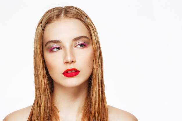 Close-up portrait of young confident woman with bright make up.