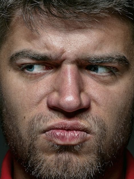 Close up portrait of young and emotional caucasian man. Highly detail photoshoot of male model with well-kept skin and bright facial expression. Concept of human emotions. 