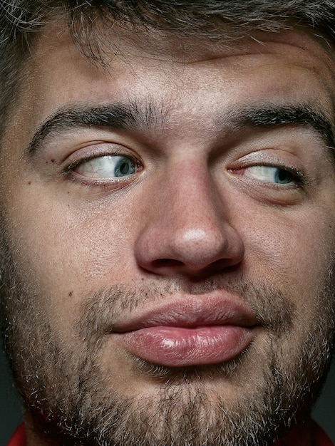 Close up portrait of young and emotional caucasian man. Highly detail photoshot of male model with well-kept skin and bright facial expression. Concept of human emotions. Looks playful.