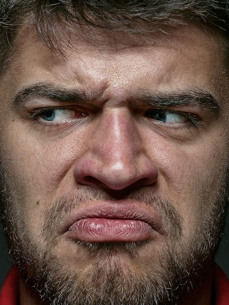 Close up portrait of young and emotional caucasian man. male model with well-kept skin and bright facial expression. Concept of human emotions. Angry.