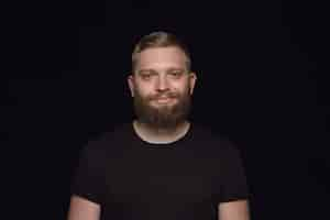 Free photo close up portrait of young man isolated on black studio