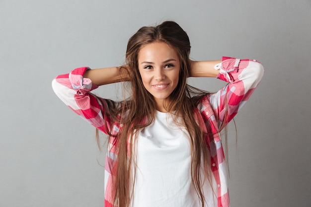 Free photo close-up portrait of young  smiling caucasian woman, touching her hair