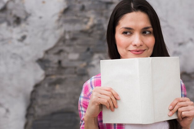 Close-up positive woman holding a book