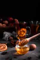 Free photo close-up of pouring honey and tea