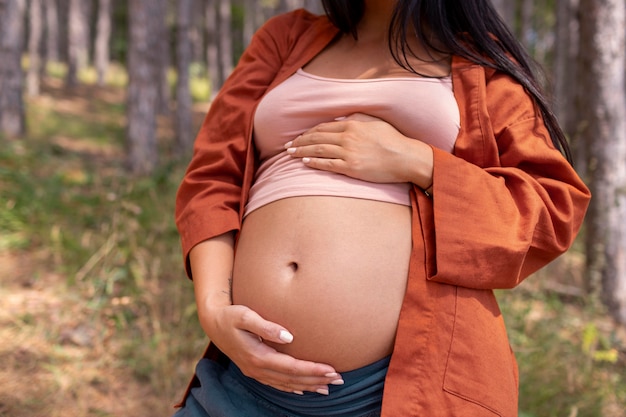 Close up pregnant woman in nature