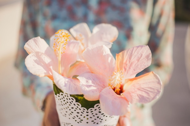 Close-up of pretty flowers with blurred person background