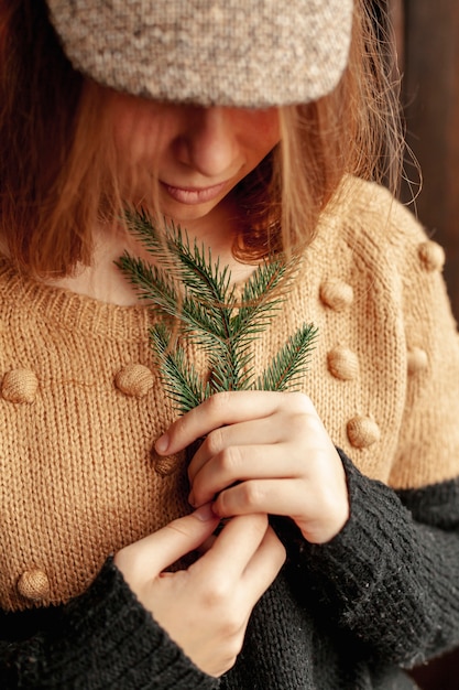 Free Photo close-up pretty girl with fir tree twig