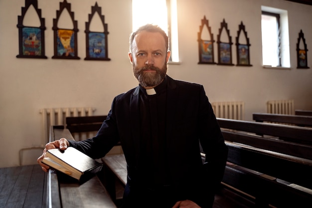 Close up on priest reading form the bible