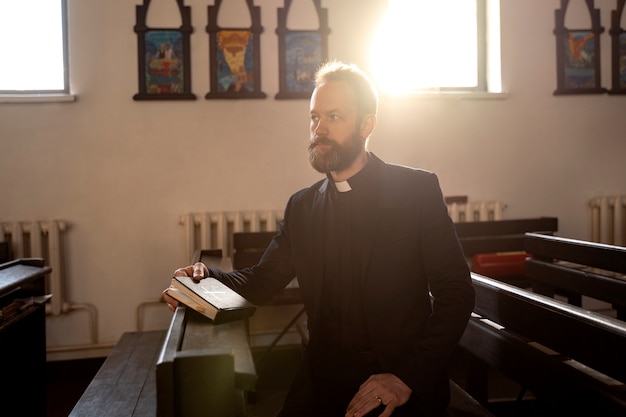 Close up on priest reading form the bible