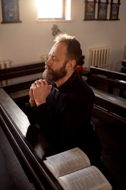 Close up on priest reading form the bible