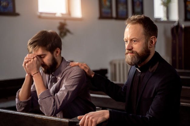 Close up on priest talking with person