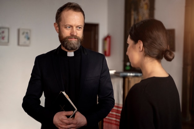 Free photo close up on priest talking with person