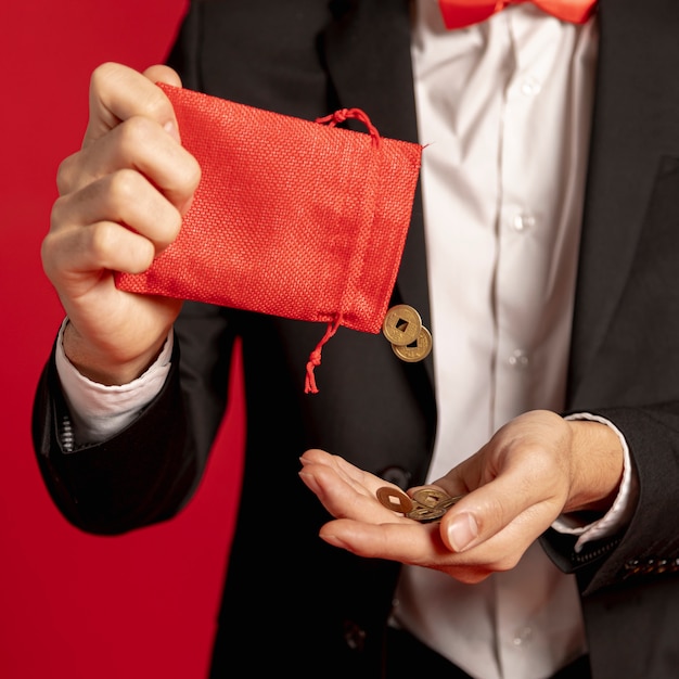 Free photo close-up of red bag with golden coins for chinese new year