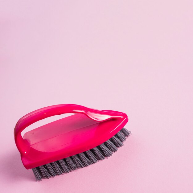 Close-up of red brush on pink surface