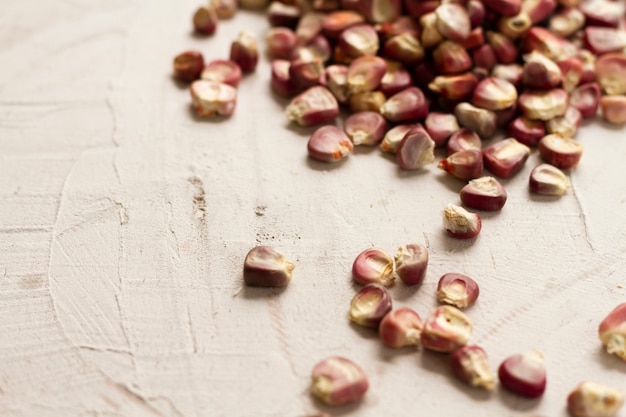 Close-up red corn kernels on table