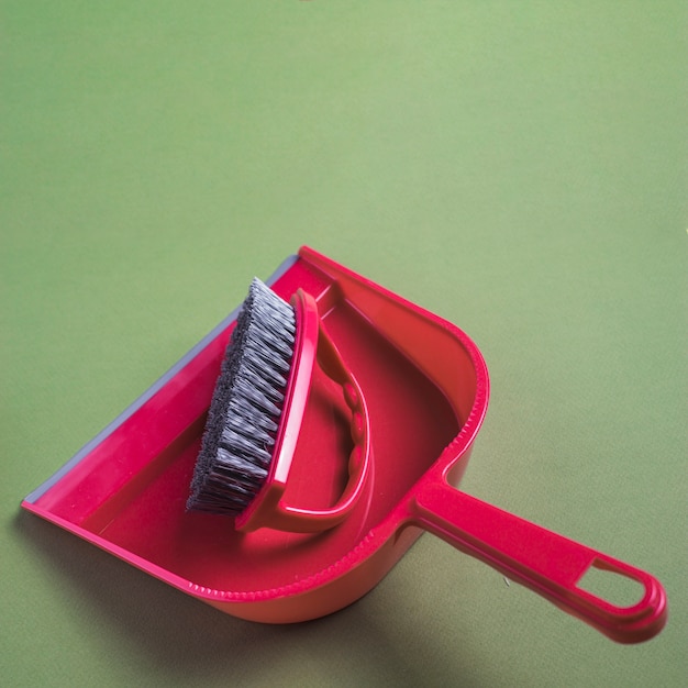 Free Photo close-up of red dustpan and brush