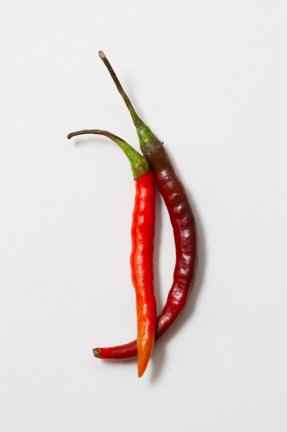 Free photo close-up red hot chili peppers with white background