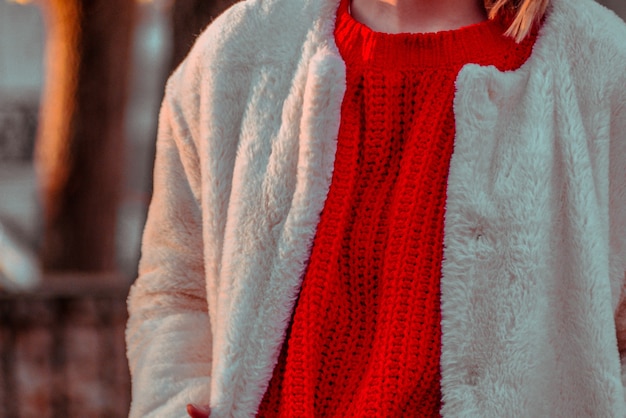 Free photo close up of red sweater and white fluffy jacket