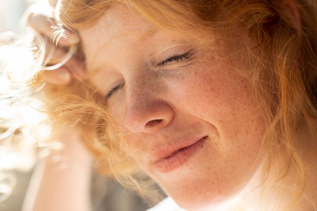 Close-up redhead woman with closed eyes