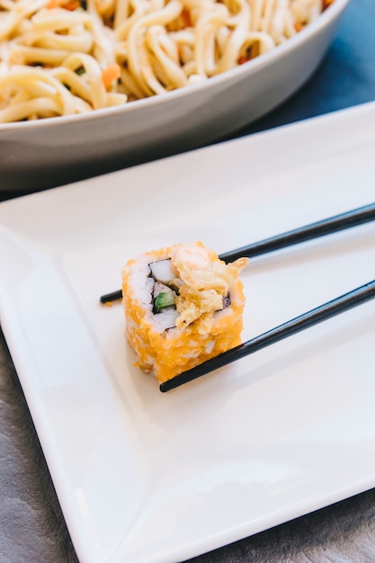 Free Photo close-up roll in chopsticks