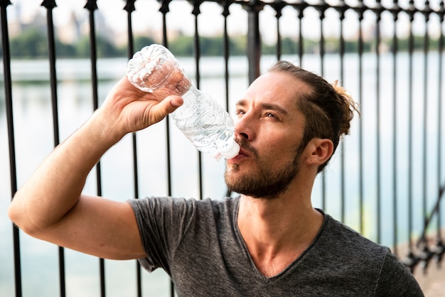 Close-up of runner drinking water