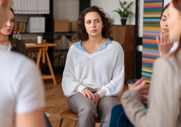 Free Photo close up sad people in therapy