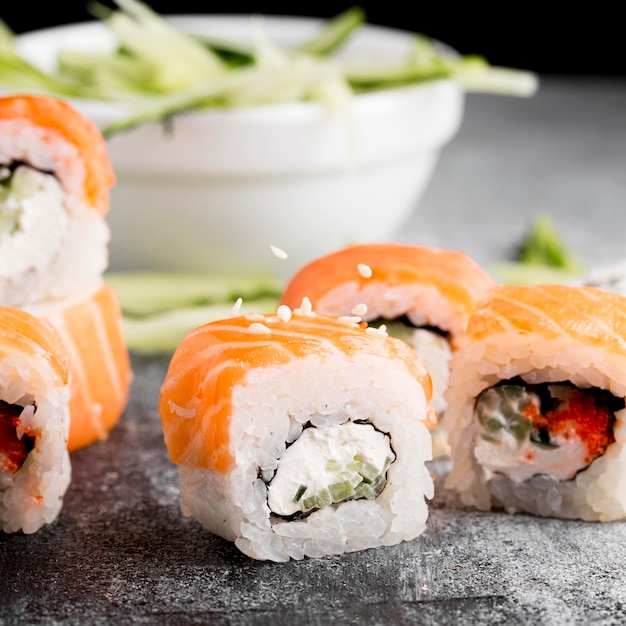 Close-up salad and fresh sushi rolls