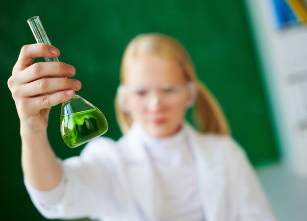 Close-up of schoolgirl holding a flask